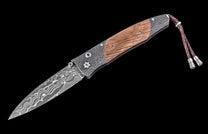 knife with wooden handle and decorative elements on a black background