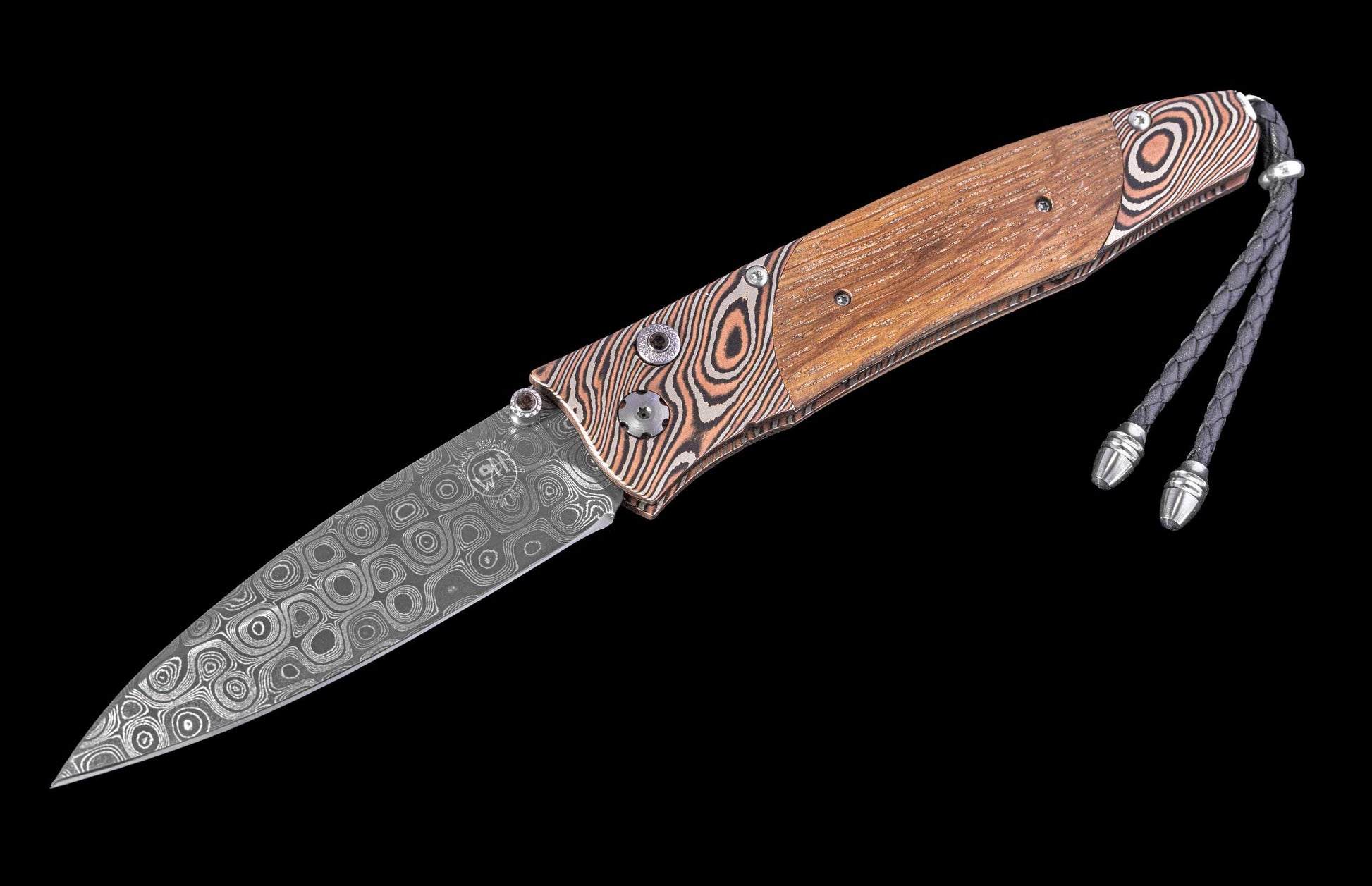 Folding knife with wooden handle and decorative blade on a black background