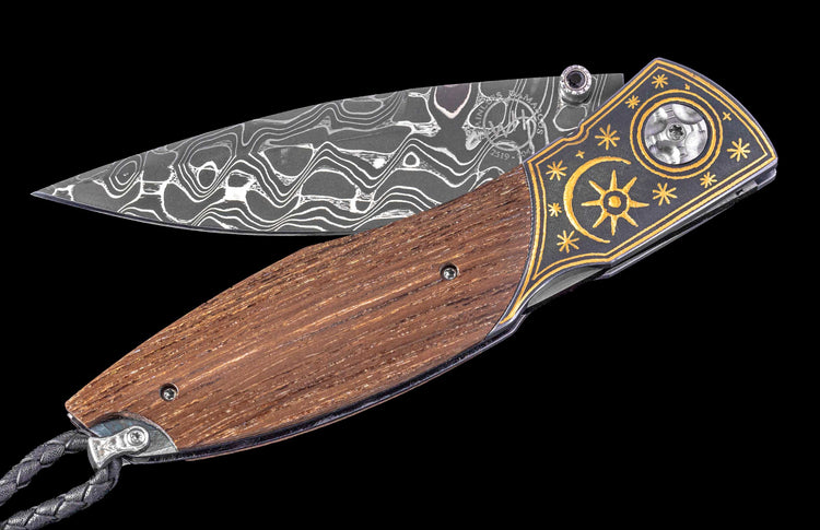 Decorative folding knife with wooden handle and intricate blade design on a black background