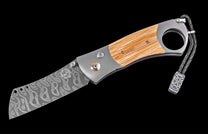 Damascus steel folding knife with wood handle scales, a finger hole, and a braided leather lanyard with a Celtic knot bead.
