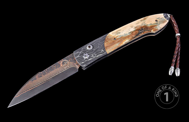 open pocket knife with fossil mammoth tusk on a black background