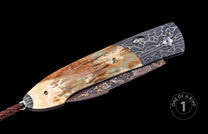 closed pocket knife with fossil mammoth tusk on a black background