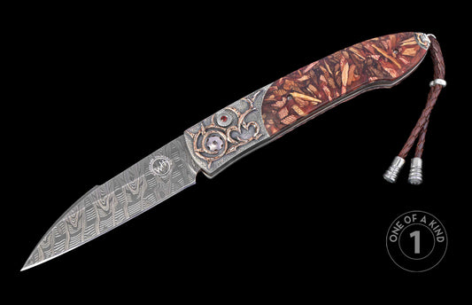Decorative knife with hand carved design on a black background. Shown open