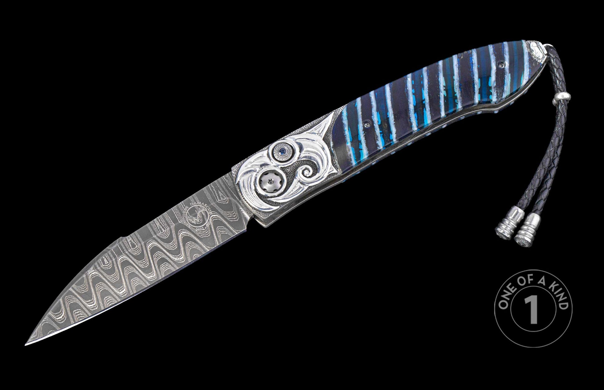 open knife with mammoth tooth handle and hand carved designs on a black background