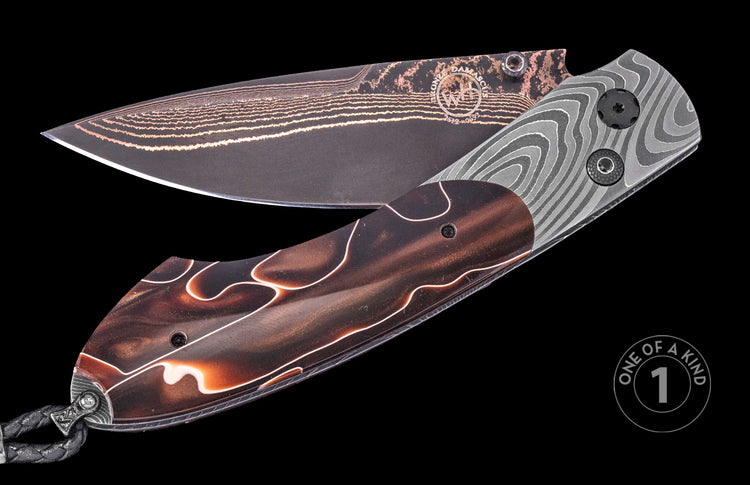 Damascus steel folding knife by WH with wavy patterned handle, copper accents, and braided lanyard, one-of-a-kind design, side view