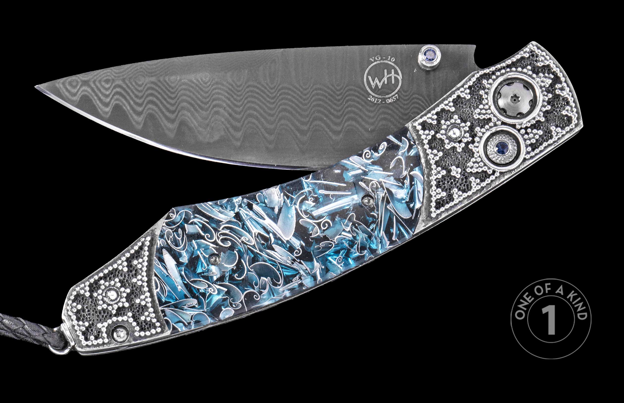 Damascus steel folding knife with blue resin handle and silver filigree, by WH, featuring sapphire accents and textured bolsters, one-of-a-kind, side view