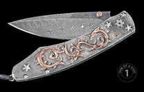 Damascus steel folding knife with textured silver handle, copper scrollwork, star inlays, and black lanyard, one of a kind