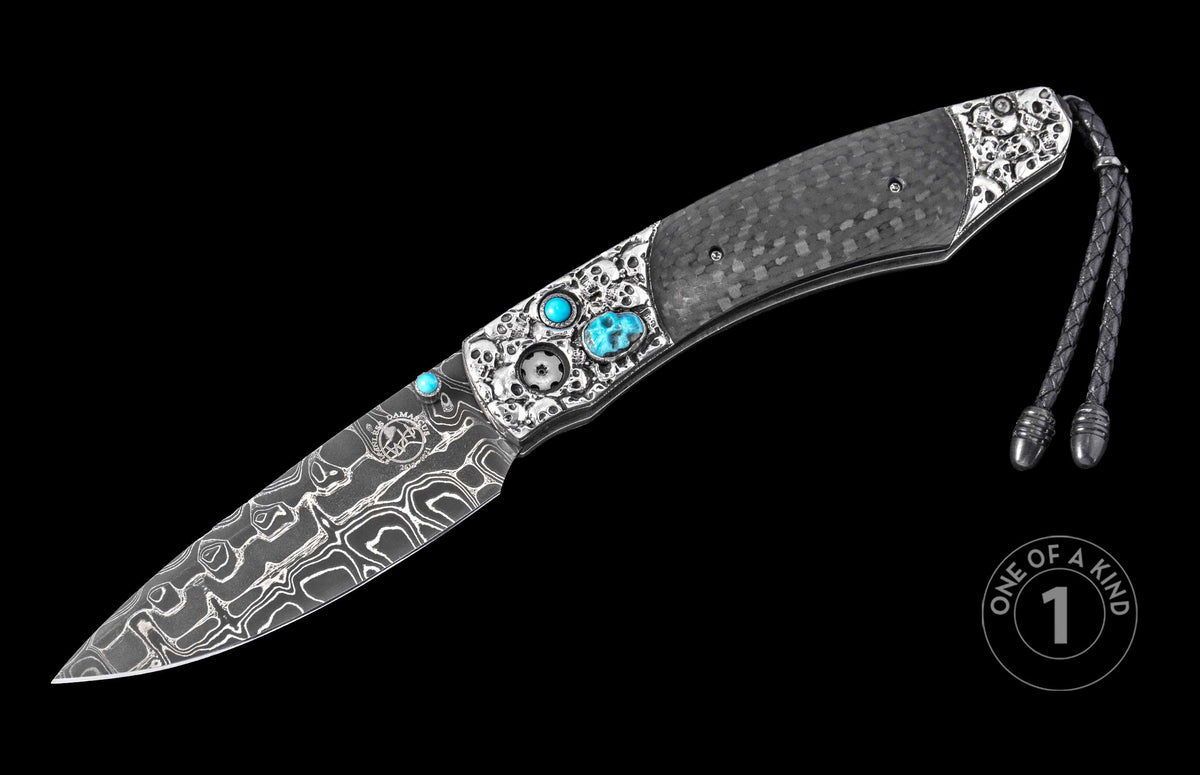 Damascus steel knife with carbon fiber handle by Karambit, featuring skull engravings, turquoise inlays, and braided lanyard, side view