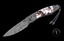 Damascus steel knife with marbled white and black handle by custom artisan, featuring braided lanyard and intricate blade pattern, side view