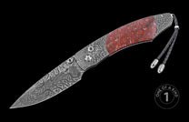 Damascus steel knife with red stone inlay and braided lanyard, one of a kind, side view on black background