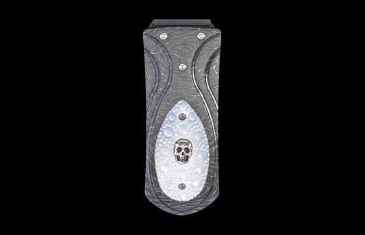 front view of a Money Clip with damascus steel frame and a silver skull set in carved mother of pearl on a black background
