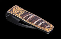 Black and gold money clip with floral engraving and fossilized wood inlay, side view, luxury design