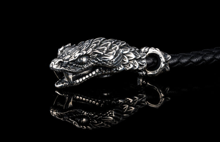 William Henry key fob features a sterling silver snake head and a round-braided black leather cord