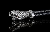 William Henry key fob features a sterling silver snake head and a round-braided black leather cord