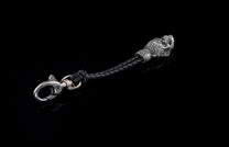 Black braided leather and ornate silver-toned key chain by Touchstone, featuring a stylized animal head and lobster clasp.
