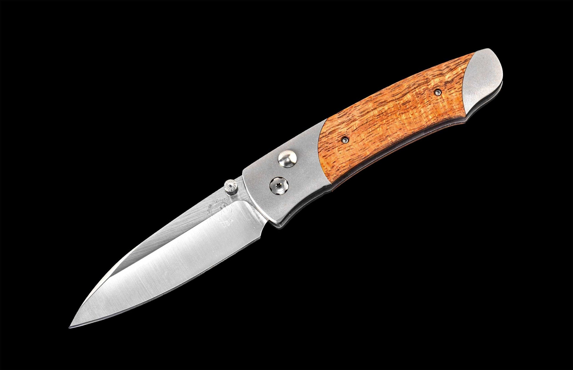 Handcrafted William Henry knife with CPM 20CV stainless steel blade and titanium  frame inlaid with curly koa wood.