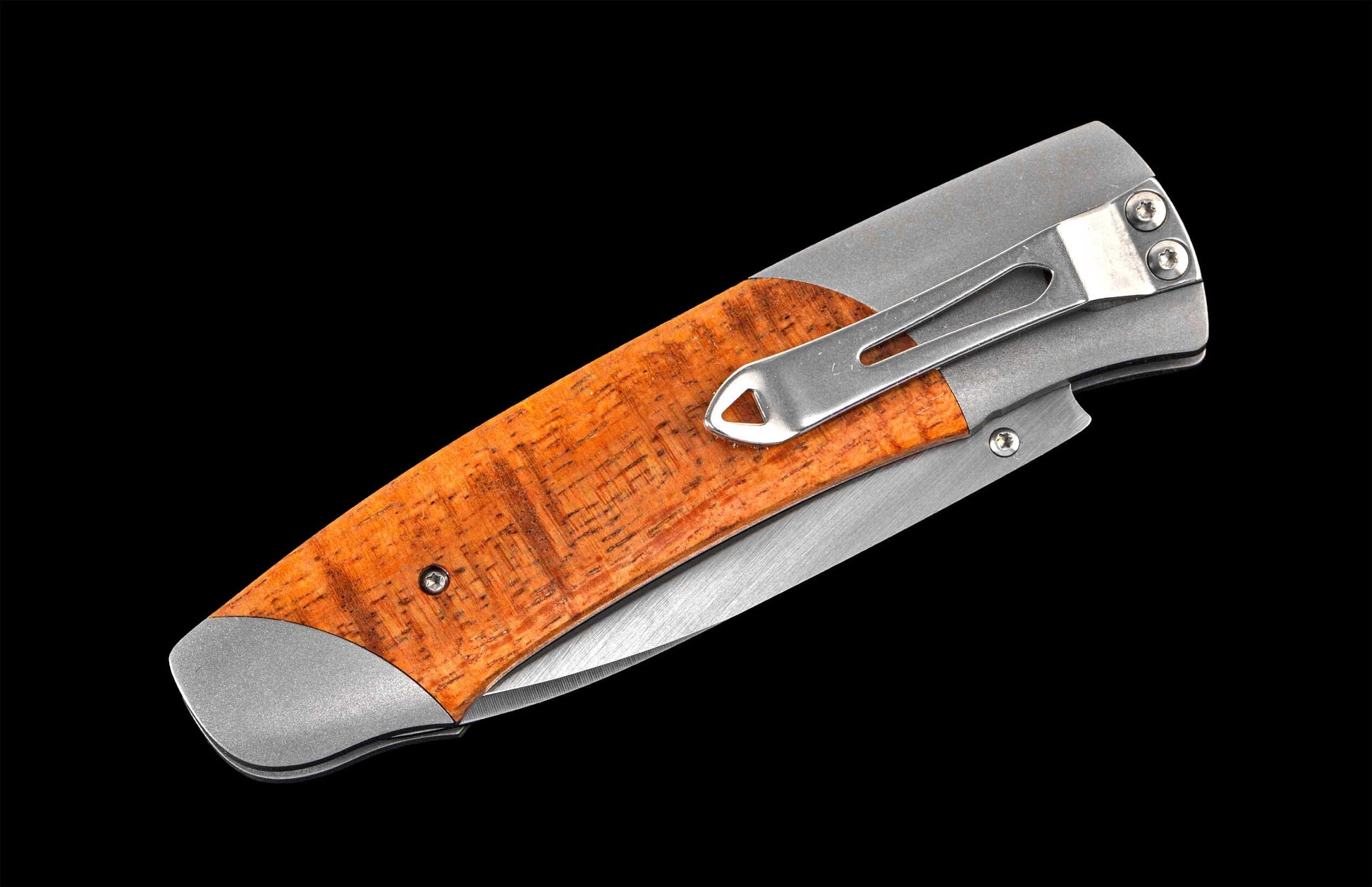Handcrafted William Henry knife with CPM 20CV stainless steel blade and titanium  frame inlaid with curly koa wood.