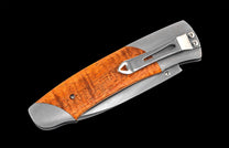 Handcrafted William Henry knife with CPM 20CV stainless steel blade and titanium  frame inlaid with curly koa wood.