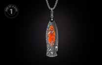 Decorative knife with dark Damascus pattern, orange stone inlay, and small gemstone, hanging from a silver chain.