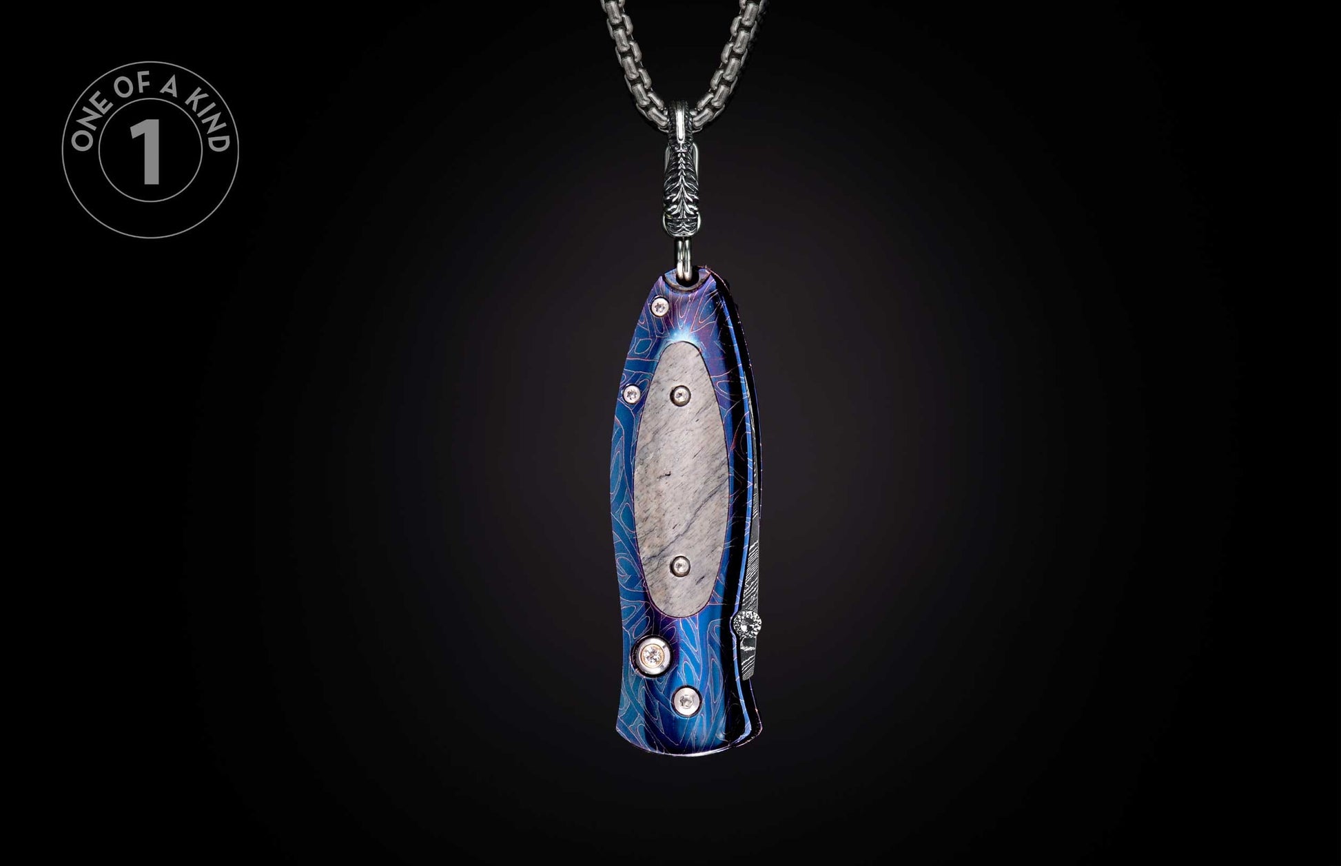 Pendant knife with iridescent blue-purple patterned handle and textured inlay, hanging from a silver chain.