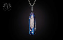 Pendant knife with iridescent blue-purple patterned handle and textured inlay, hanging from a silver chain.