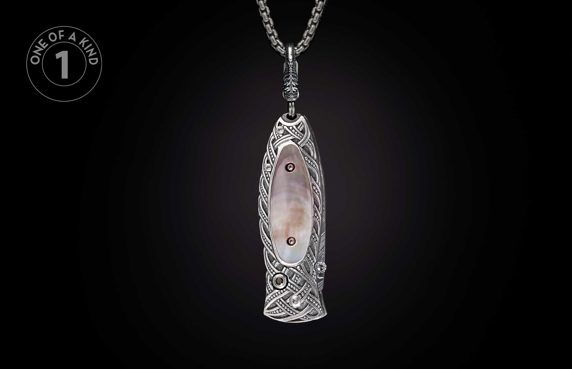 Ornate silver-toned knife featuring iridescent mother-of-pearl inlay, Celtic knot patterns, and gemstones, suspended from a chain.