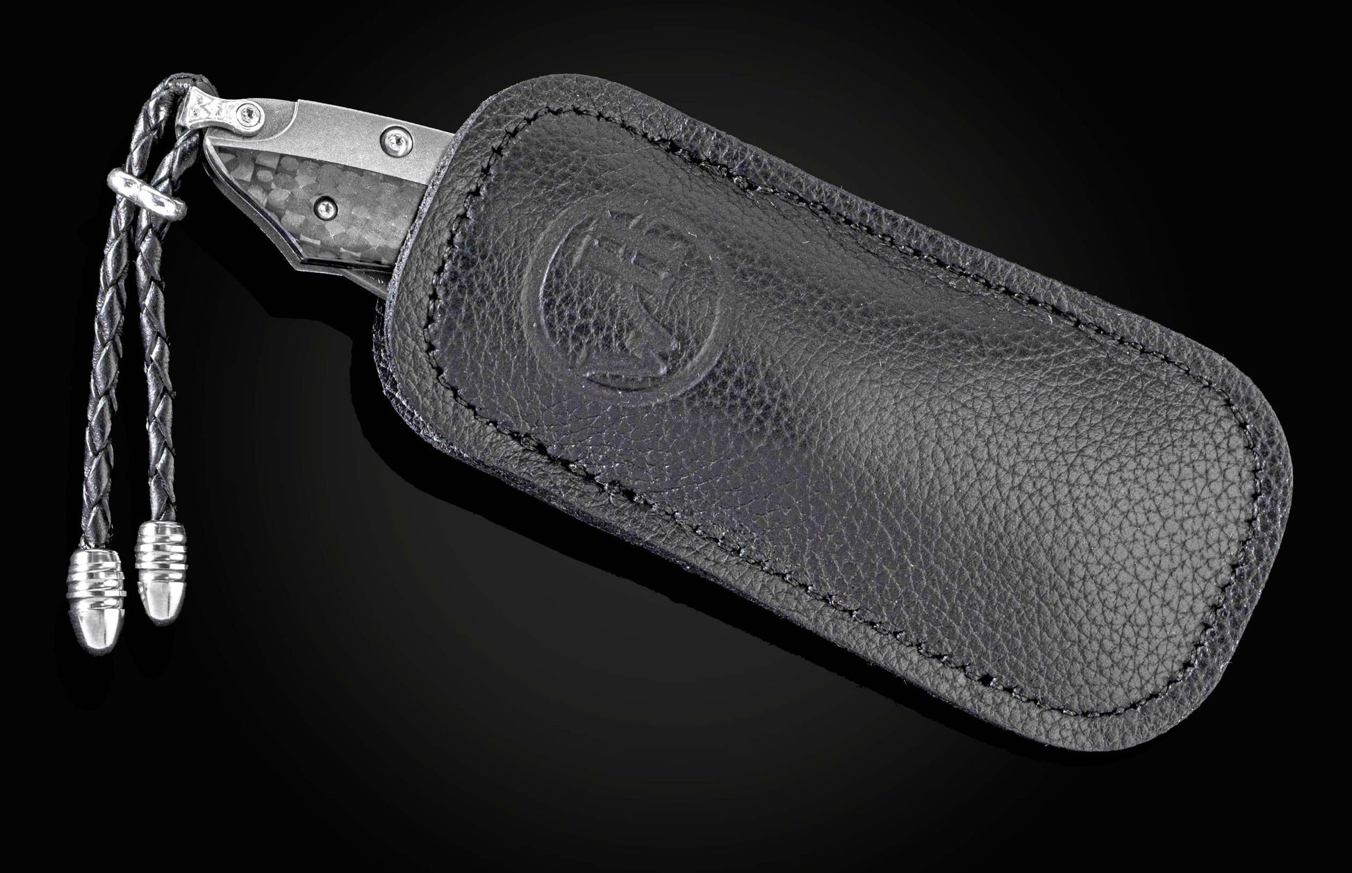 The folding titanium pocket knife with carbon fiber and Damascus steel in a leather case