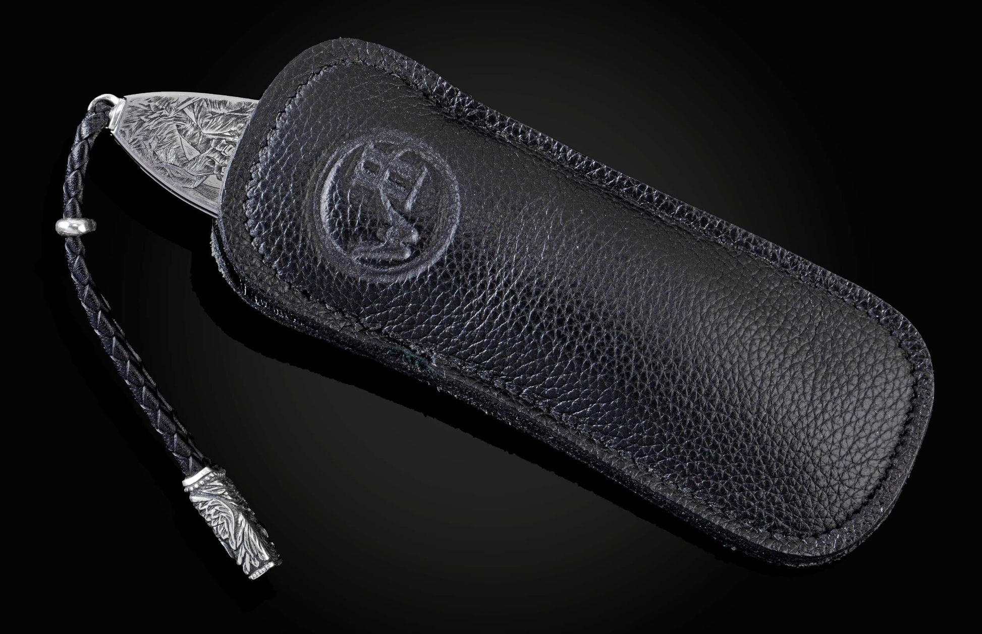 Handcrafted pocket knife from William Henry featuring a stainless steel frame hand-engraved with images of the Statue of Liberty and set with blue sapphires. The blade is hand-forged damascus steel.