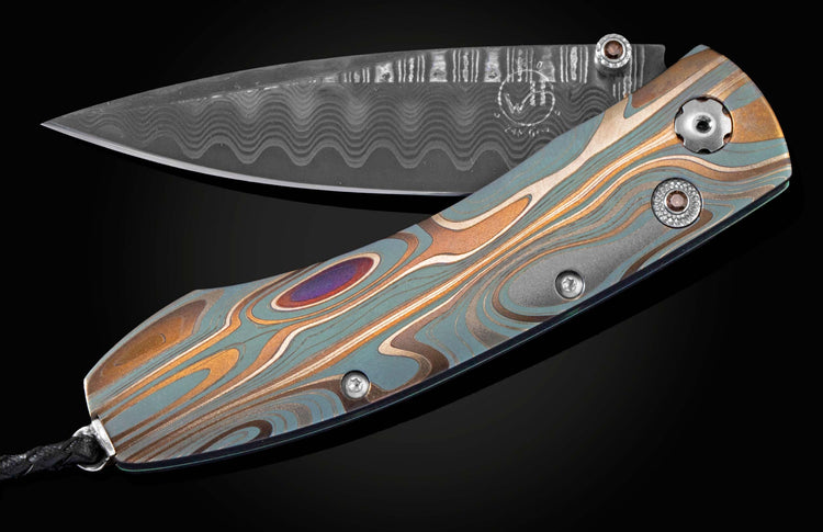 Handcrafted pocket knife from William Henry features a frame in laser engraved and anodized titanium, set with smoky quartz gemstones and a Damascus steel blade.