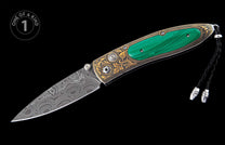 Folding knife with green malachite handle, gold engraved frame, Damascus steel blade, and black braided lanyard.