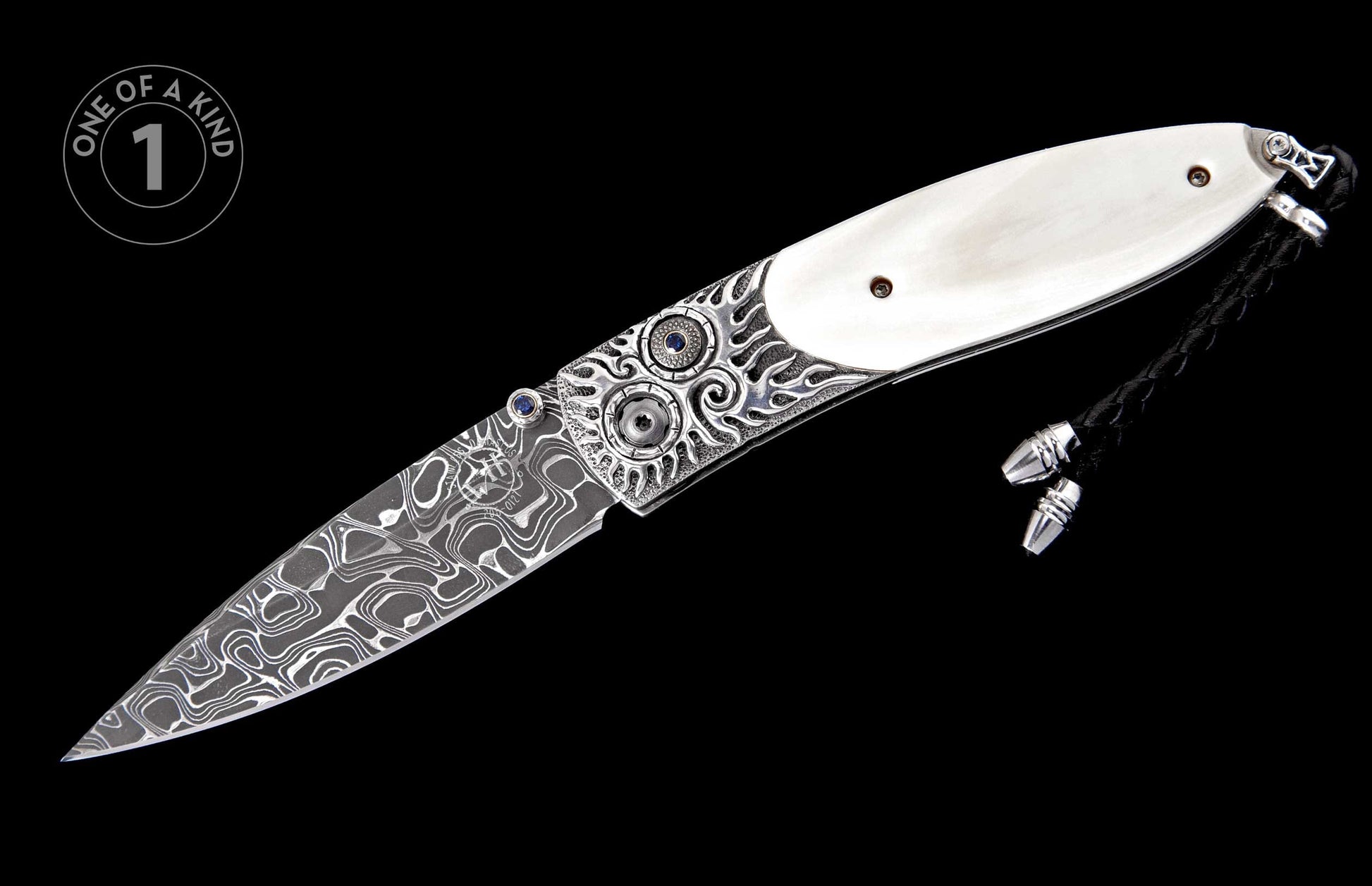 Folding knife with Damascus steel blade, ornate silver bolsters featuring blue gemstones, white handle scales, and a black braided lanyard.