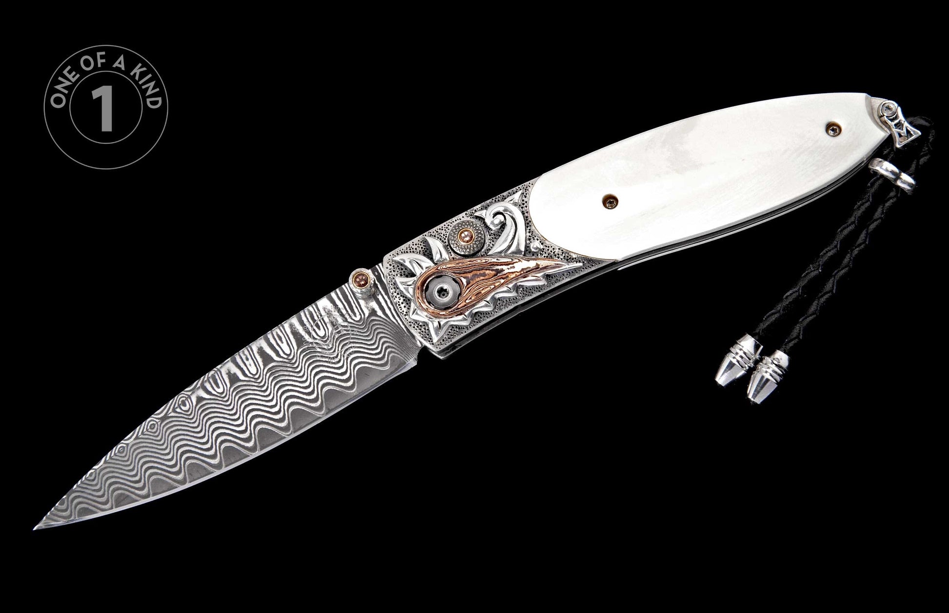 Ornate folding knife with a wavy Damascus steel blade, white handle, and detailed silver and copper engraved bolster, featuring a black braided lanyard.