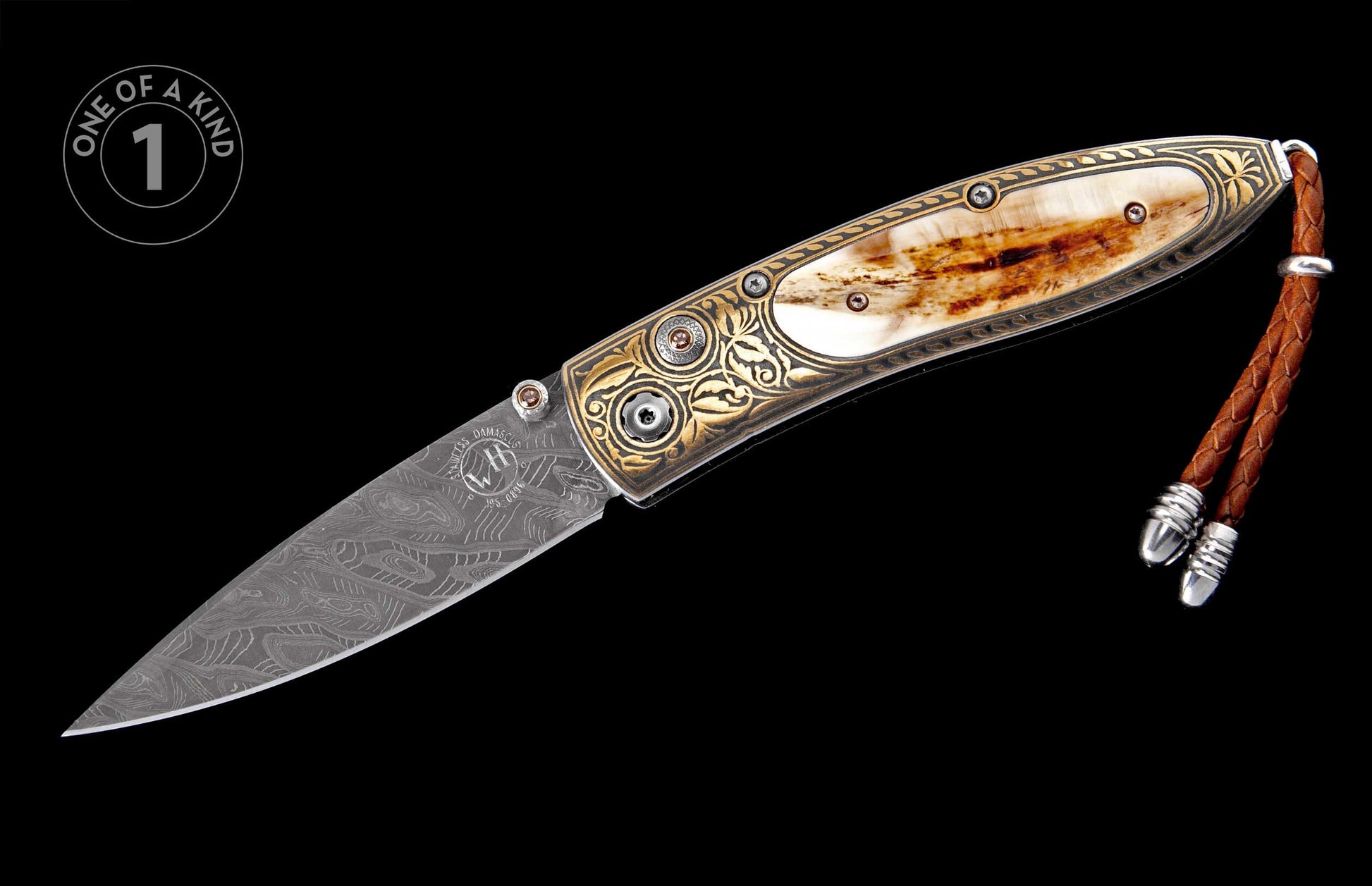 Ornate folding knife with a patterned Damascus steel blade and bone inlay handle with gold engravings, brown gems, and a leather lanyard.