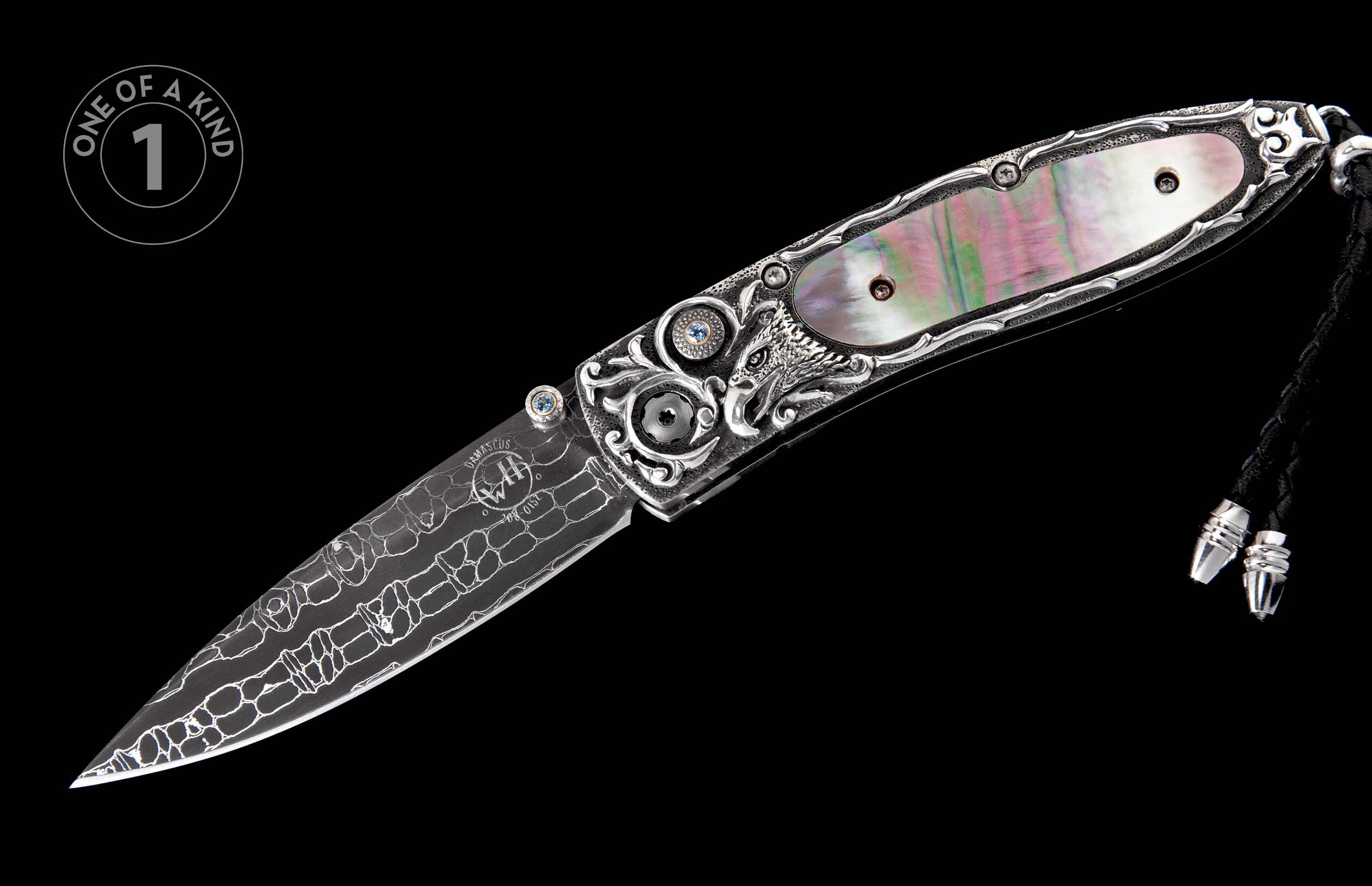 Ornate silver folding knife with a Damascus blade, iridescent mother-of-pearl handle, wolf carving, blue gemstones, and a braided black cord.