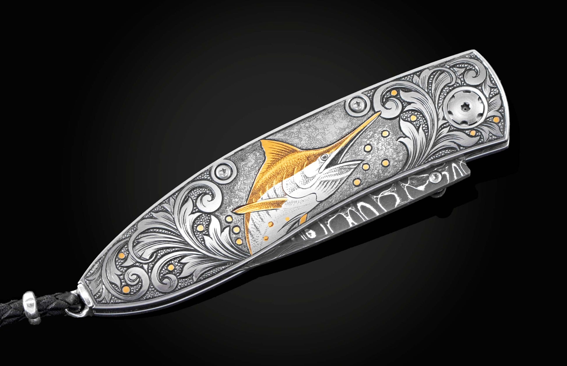 Handcrafted pocket knife from William Henry features a hand-engraved image of a Marlin with 24K gold inlays and set with dark Kashmir blue topaz and a hand forged Damascus steel blade.