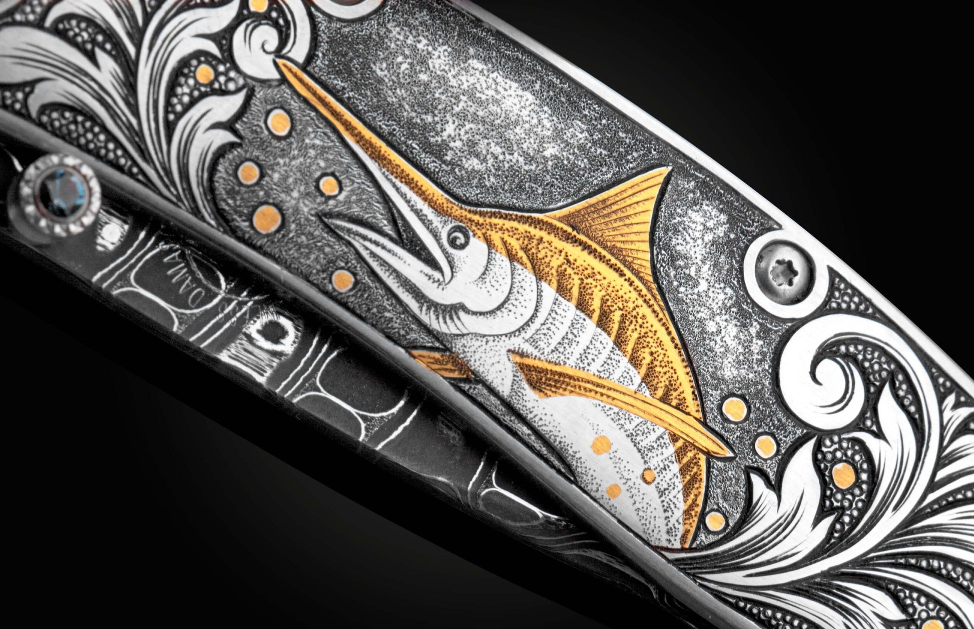 Handcrafted pocket knife from William Henry features a hand-engraved image of a Marlin with 24K gold inlays and set with dark Kashmir blue topaz and a hand forged Damascus steel blade.