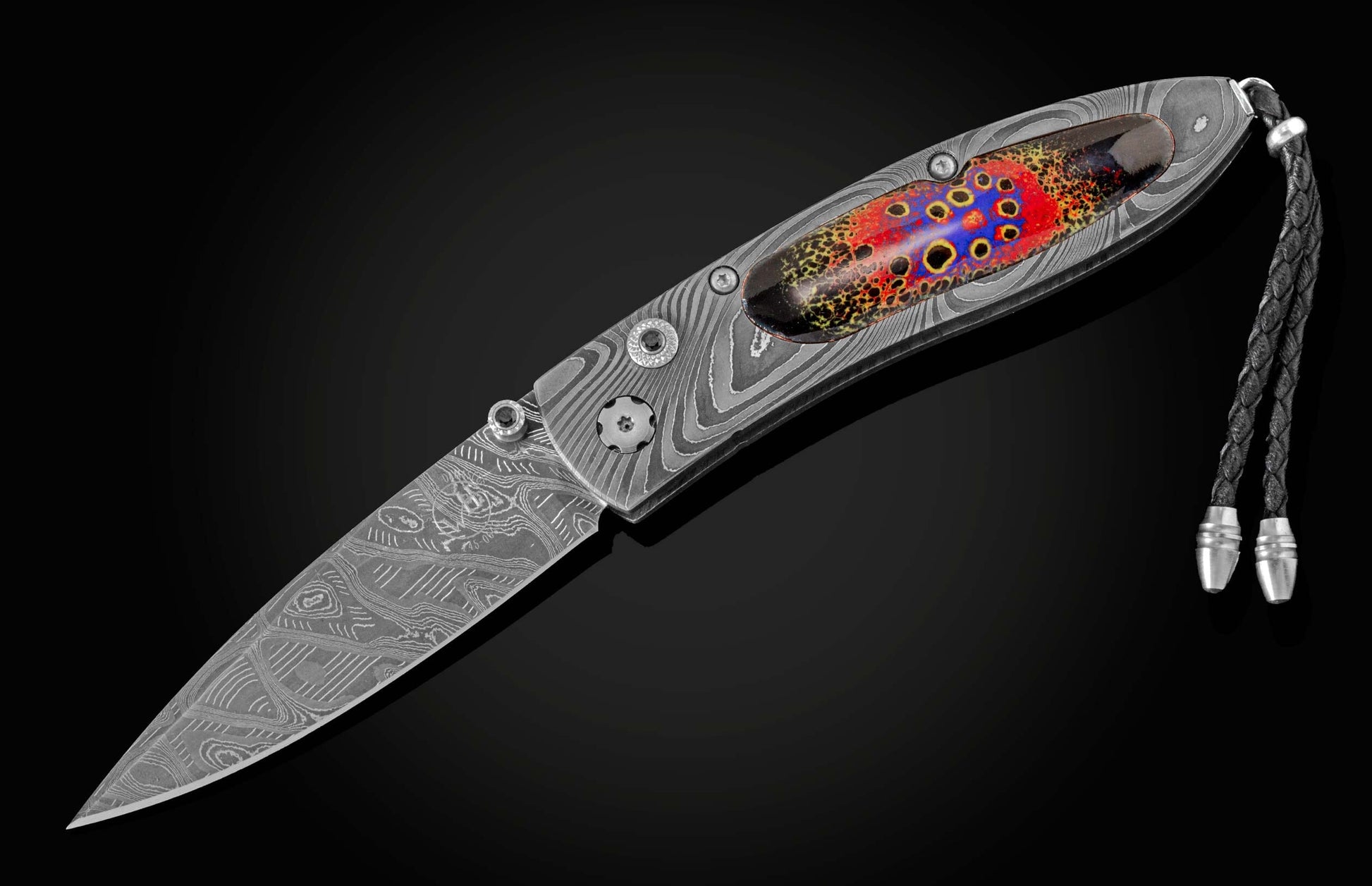  inlaid with enamel artistry by Little Lake Metals. The blade is hand-forged Damascus and the button lock and thumb stud are set with spinel gemstones.