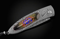 Handcrafted pocket knife from William Henry features a frame in hand-forged Damascus steel