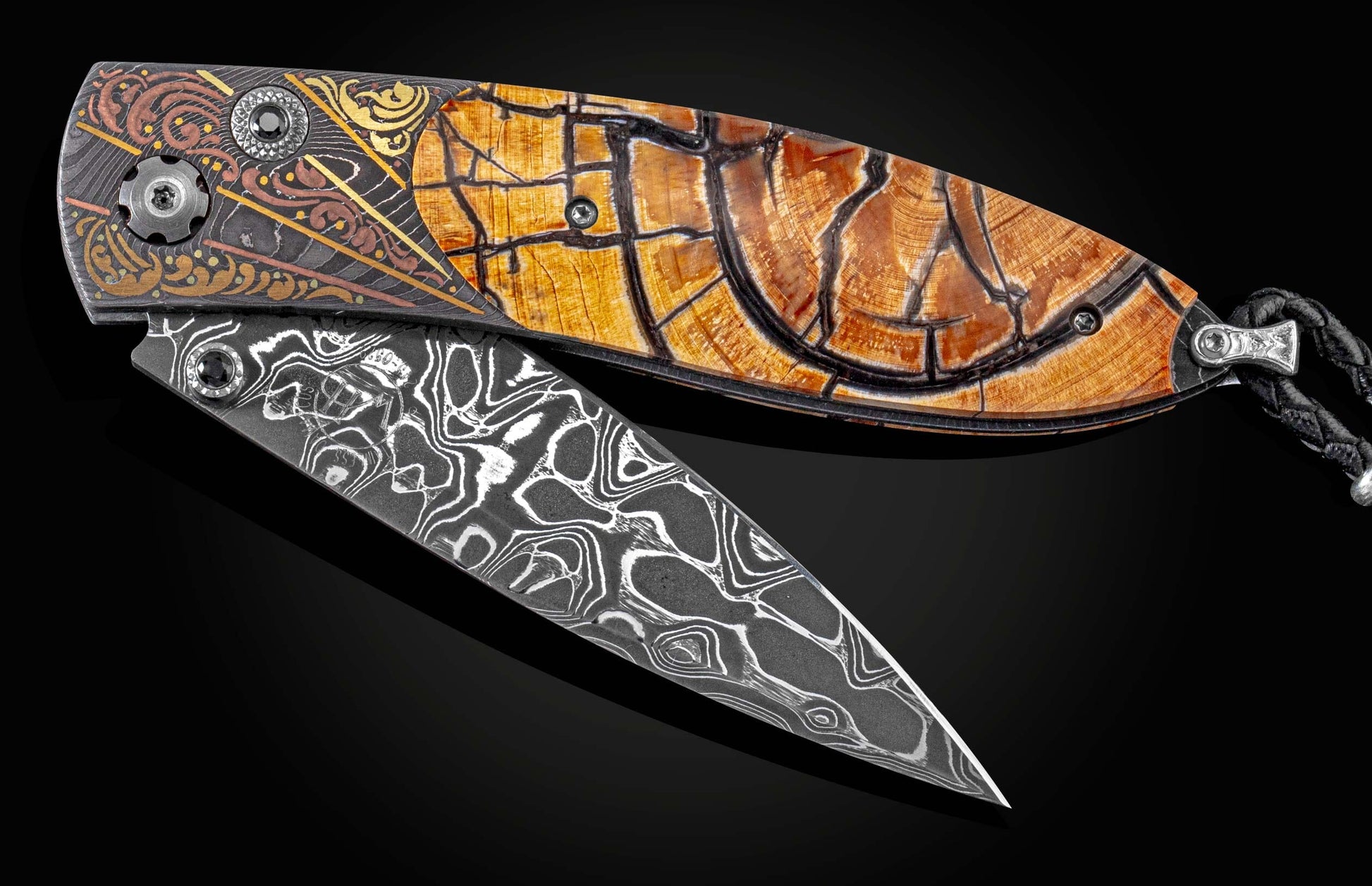 Handcrafted pocket knofe from William Henry featuring a hand-forged damascus frame by Chad Nichols, with hand-engraved inlays by Tyler Prince, woolly mammoth tooth scales, set with spinel gemstones, and a hand-forged 'Intrepid' damascus steel blade, also 