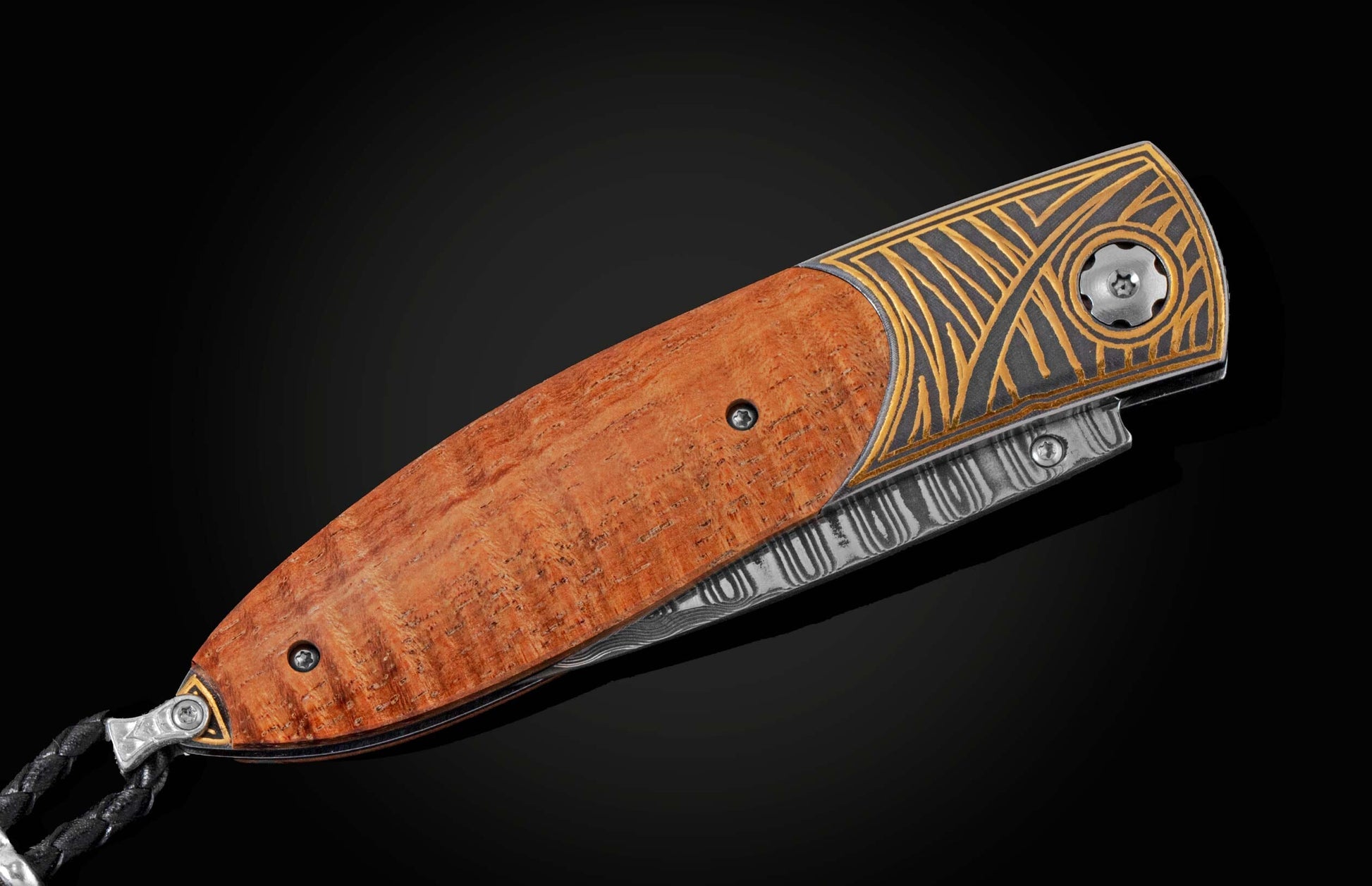 Handcrafted pocket knife with Damascus steel blade and scales featuring curly koa wood and 24K gold koftgari. Displayed on a black background with the knife closed.