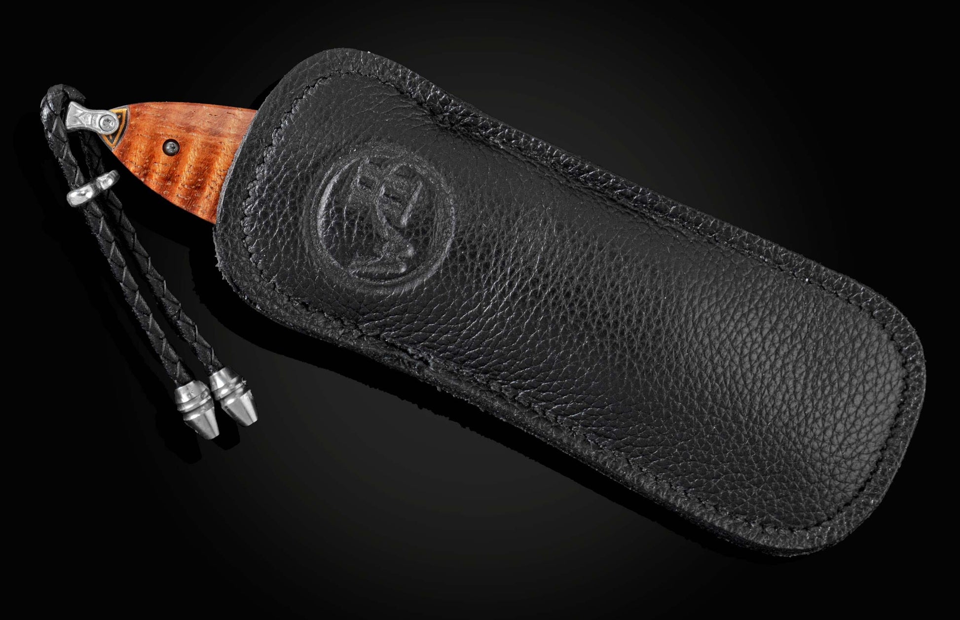 Handcrafted pocket knife with Damascus steel blade and scales featuring curly koa wood and 24K gold koftgari. Displayed on a black background in a leather carrying case.