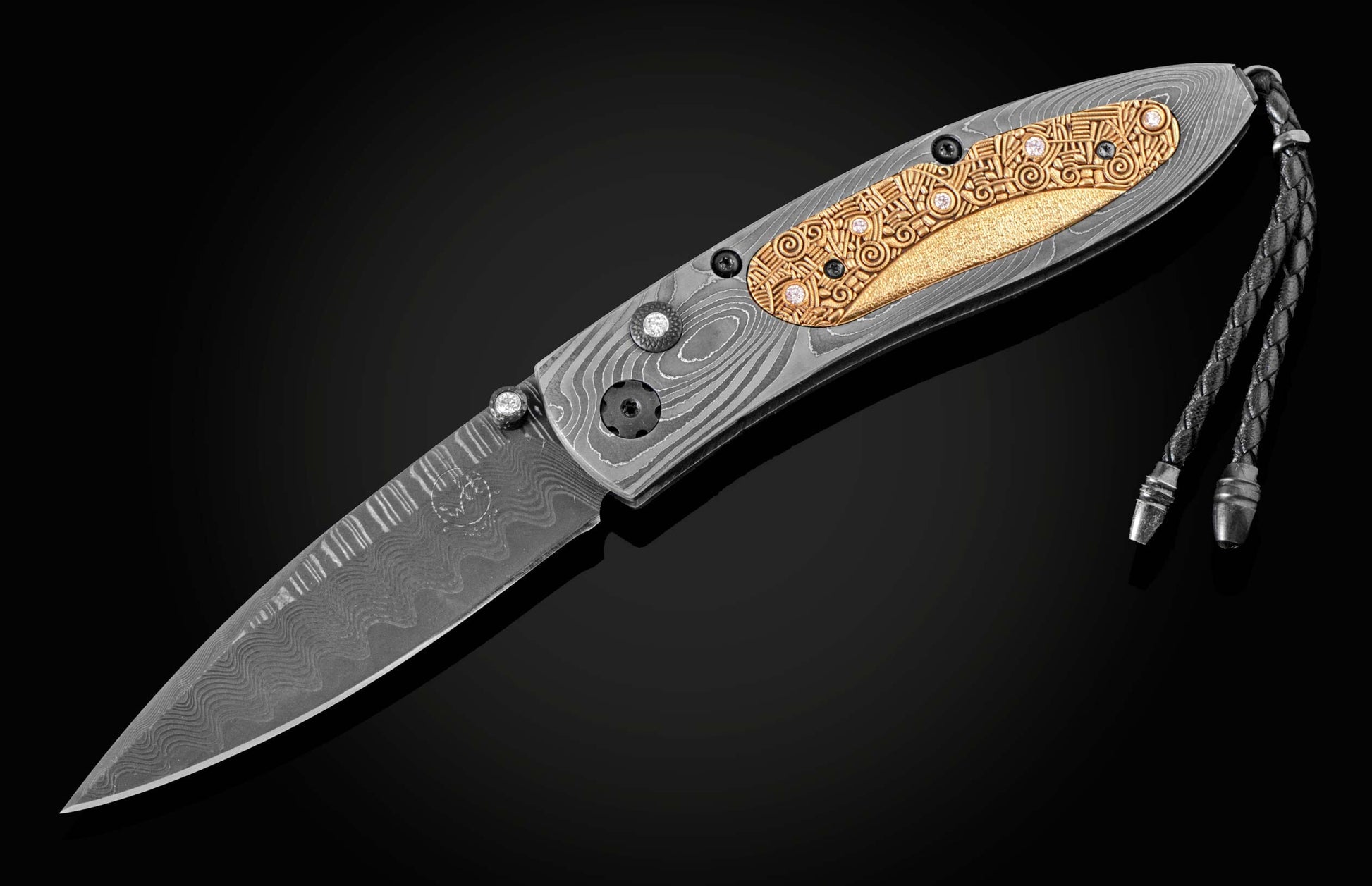 Handmade pocket knife from William Henry features a frame in hand-forged Damascus inlaid with 18K gold scales embedded with white diamonds by Alex Sepkus. The blade is hand forged Damascus steel.