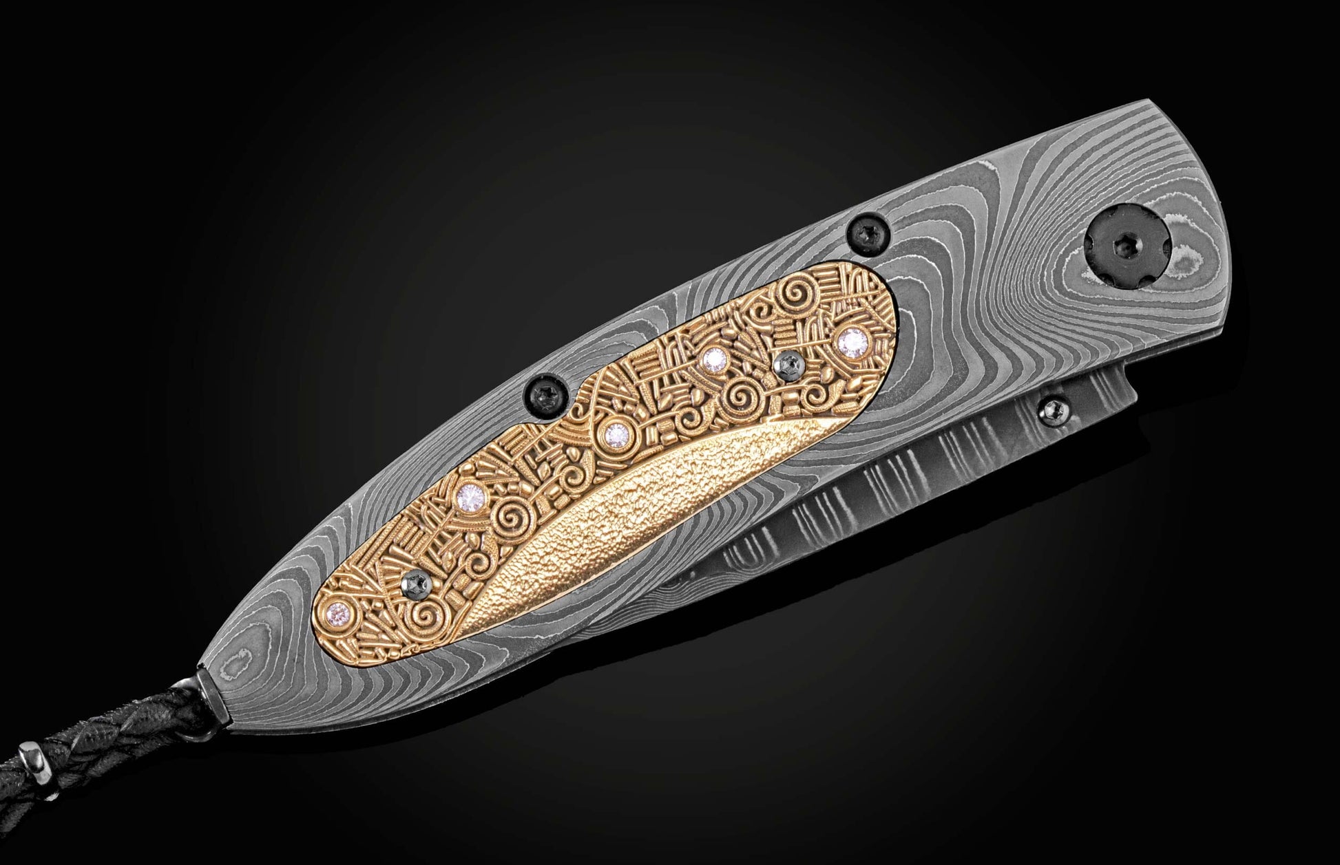 Handmade pocket knife from William Henry features a frame in hand-forged Damascus inlaid with 18K gold scales embedded with white diamonds by Alex Sepkus. The blade is hand forged Damascus steel.