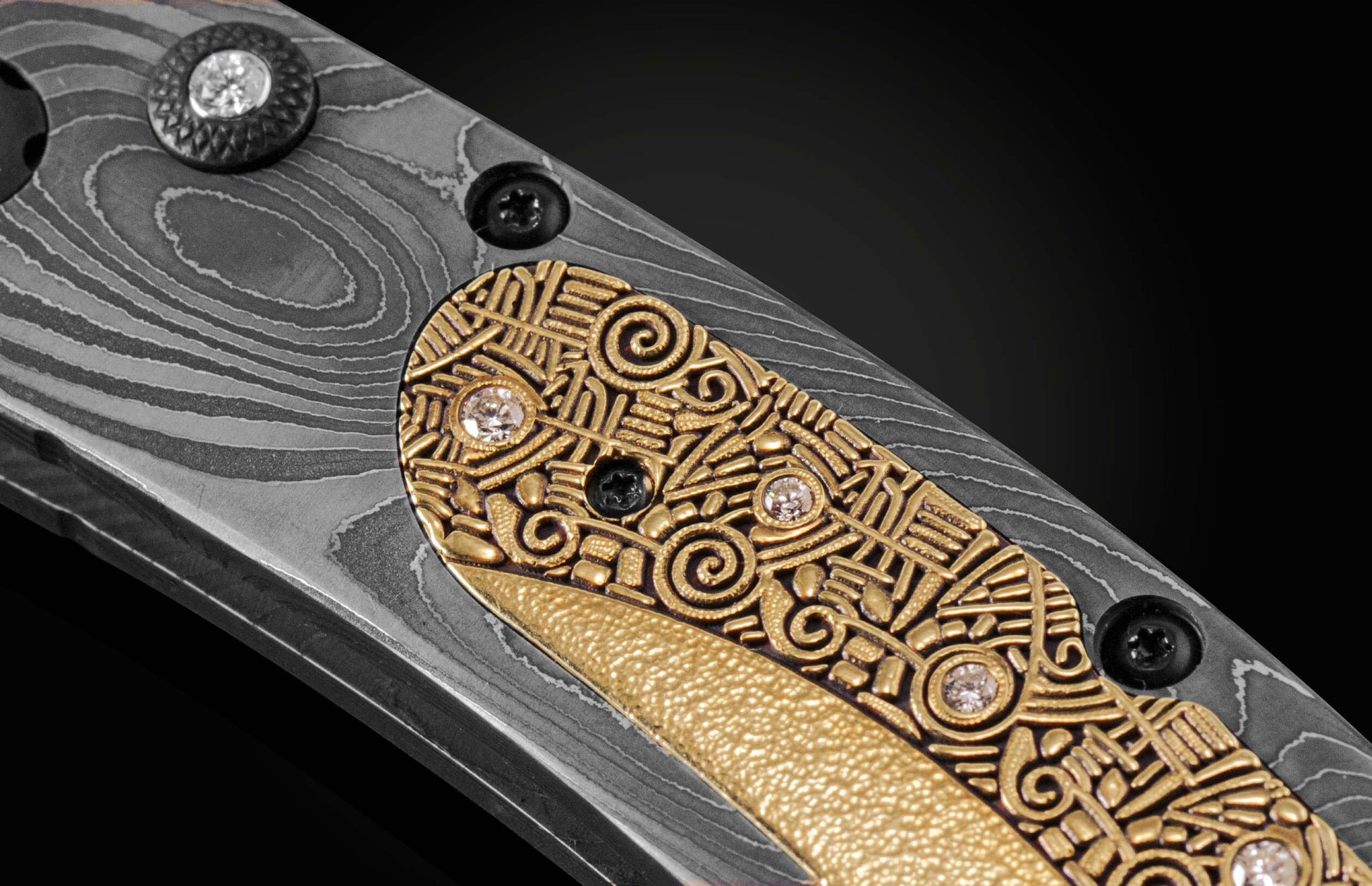 Handmade pocket knife from William Henry features a frame in hand-forged Damascus inlaid with 18K gold scales embedded with white diamonds by Alex Sepkus. The blade is hand forged Damascus steel.