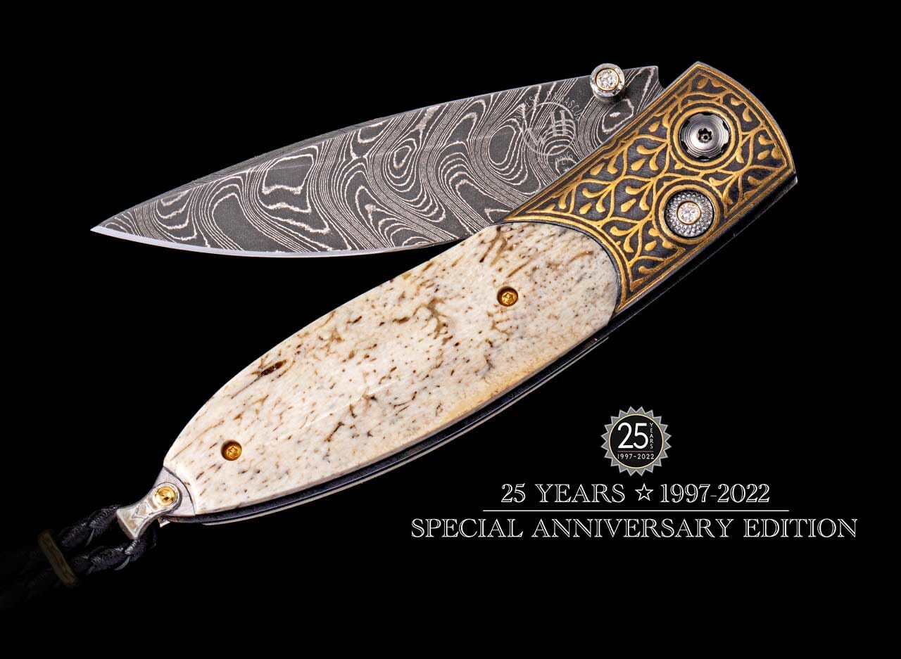 Folding knife with a swirling Damascus steel blade, mottled bone handle, and ornate gold bolster inlaid with clear gems.