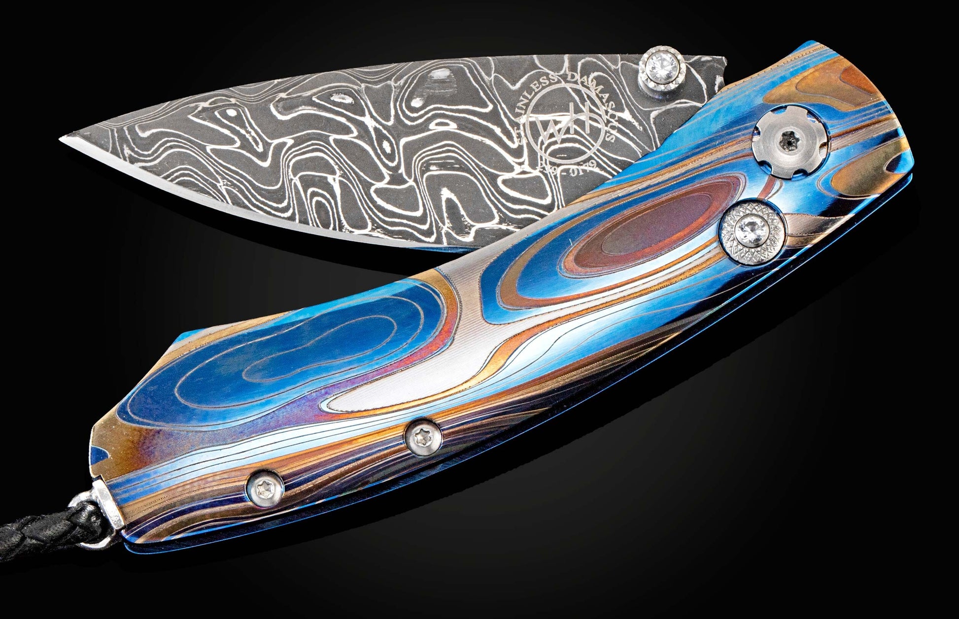 Handcrafted William Henry knife featuring anodized blue and laser engraved titanium frame, white topaz gemstones, and a hand-forged Damascus steel blade by Chad Nichols