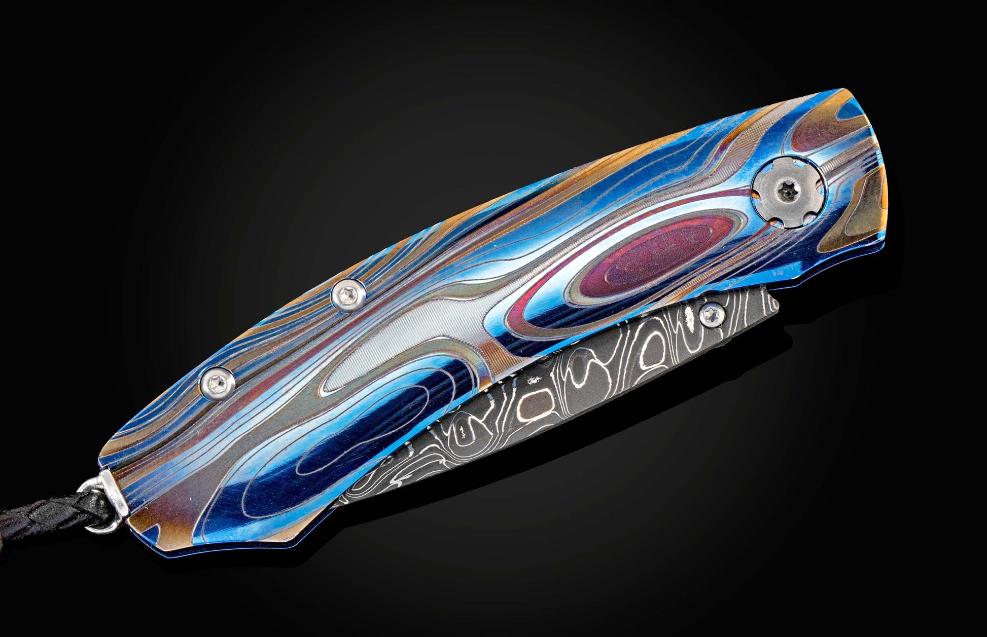 Handcrafted William Henry knife featuring anodized blue and laser engraved titanium frame