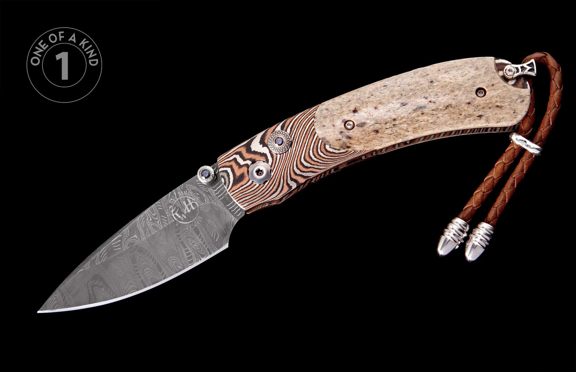 Folding knife with patterned Damascus blade, two-tone handle of striped and speckled material, blue gemstone accents, and leather lanyard.
