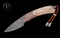 Folding knife with patterned Damascus blade, two-tone handle of striped and speckled material, blue gemstone accents, and leather lanyard.