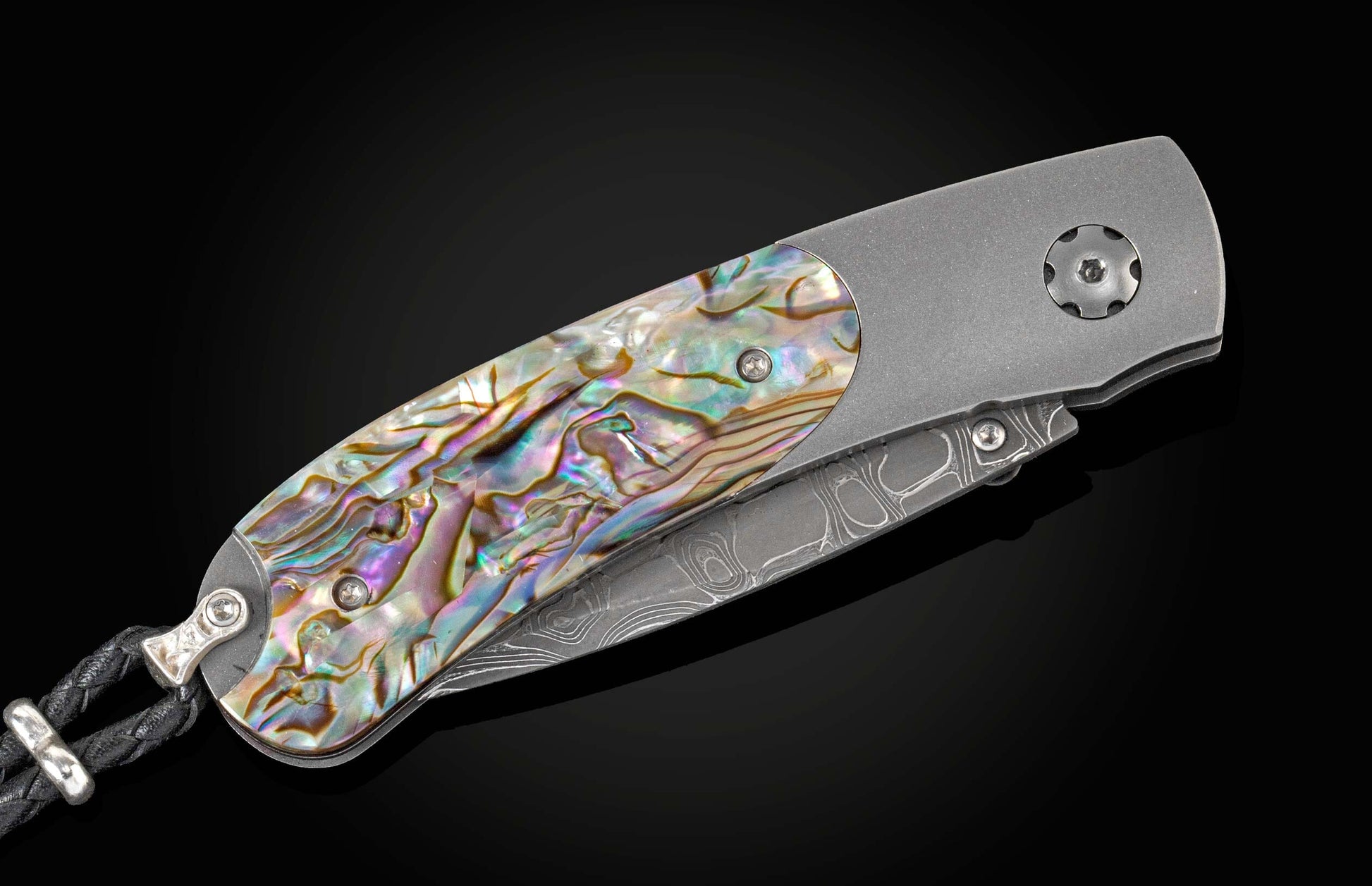 Handcrafted William Henry knife featuring a titanium frame and inlaid with Abalone scales